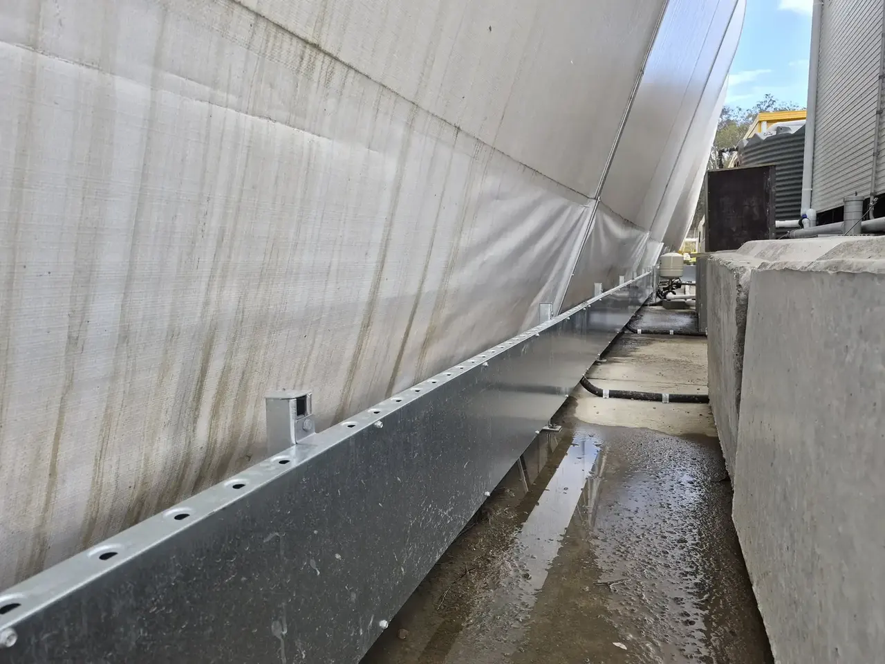 Cable tray running along the base of a shed wall