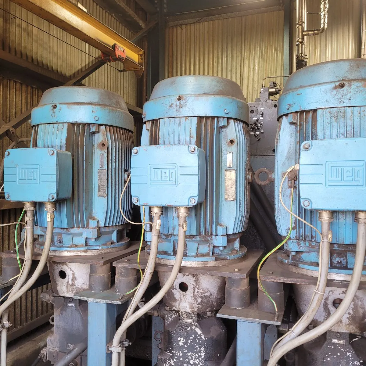 Closer view of the three motors, with their terminal boxes and cable entries