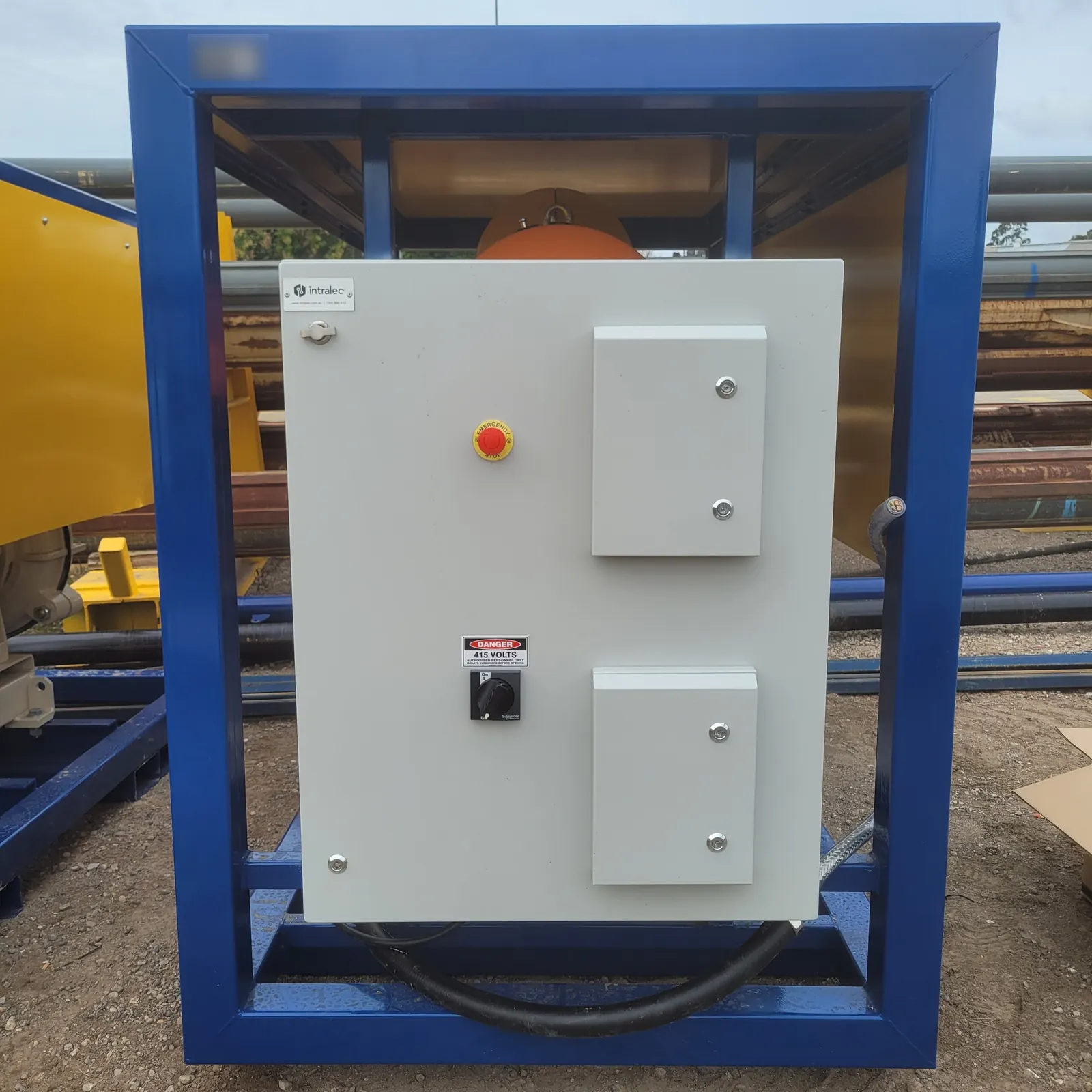 The finished VSD control panel on the front of the pump skid, with emergency stop and isolator