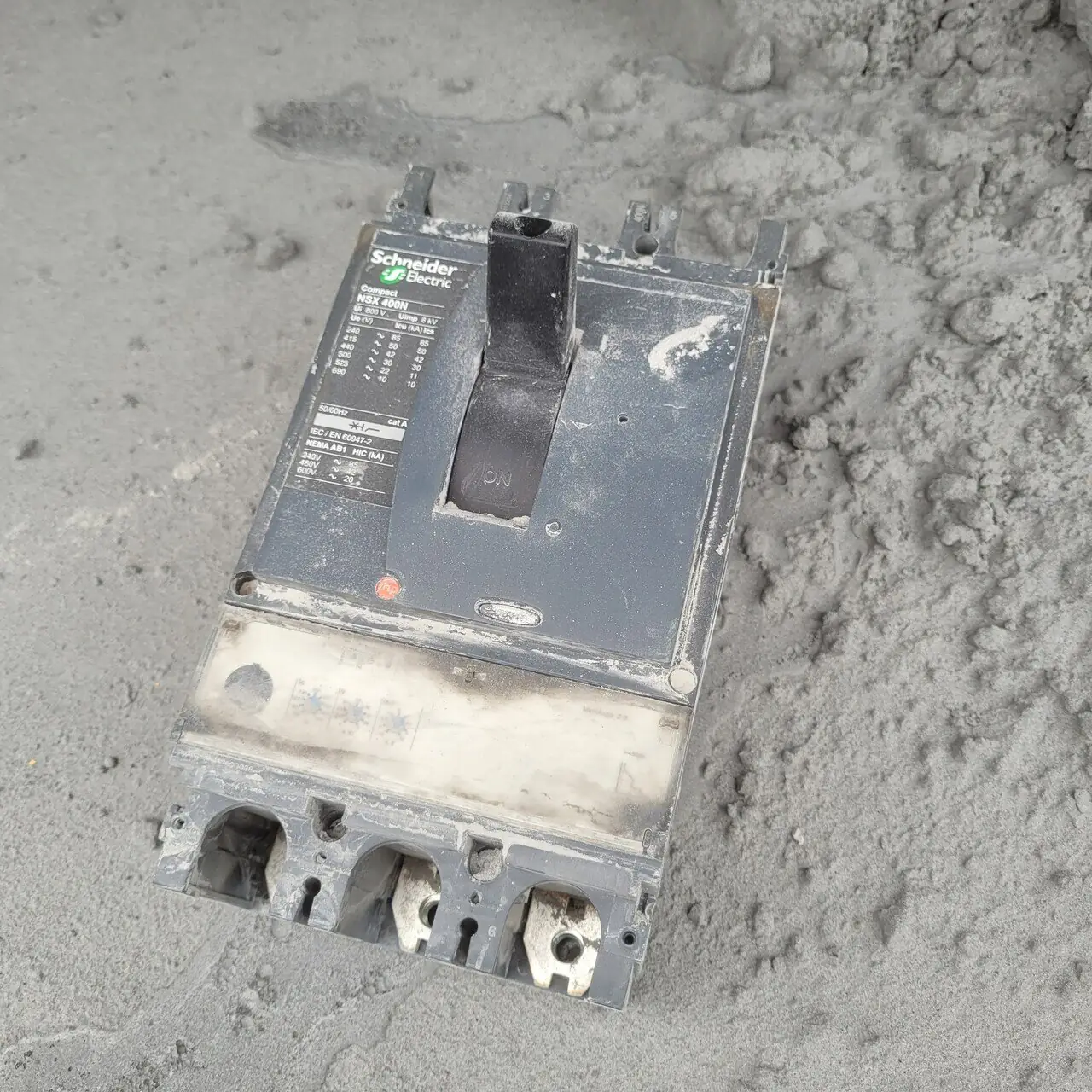 Removed main circuit breaker showing heavy dust contamination