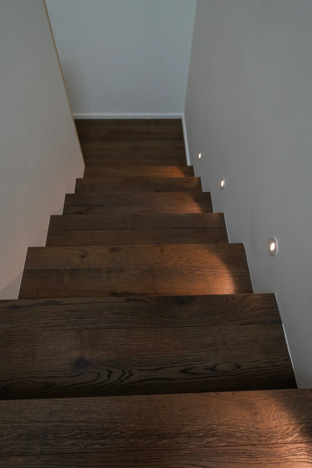 Step lighting set into the stair wall