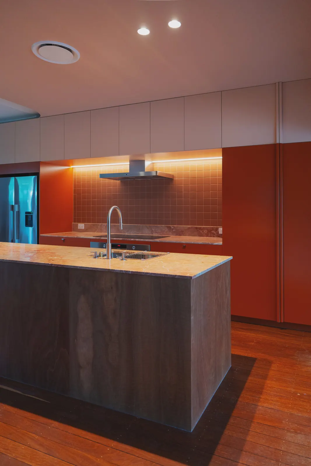 Kitchen lighting over the island, with a strip light under the cabinets
