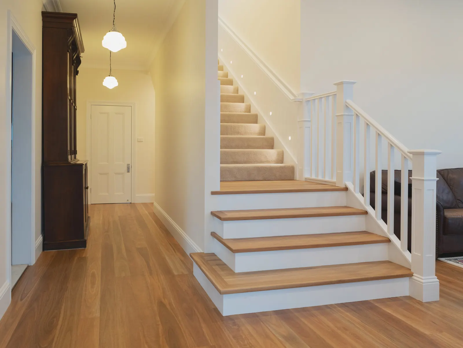 Stair lighting and vintage pendant lights along the hallway