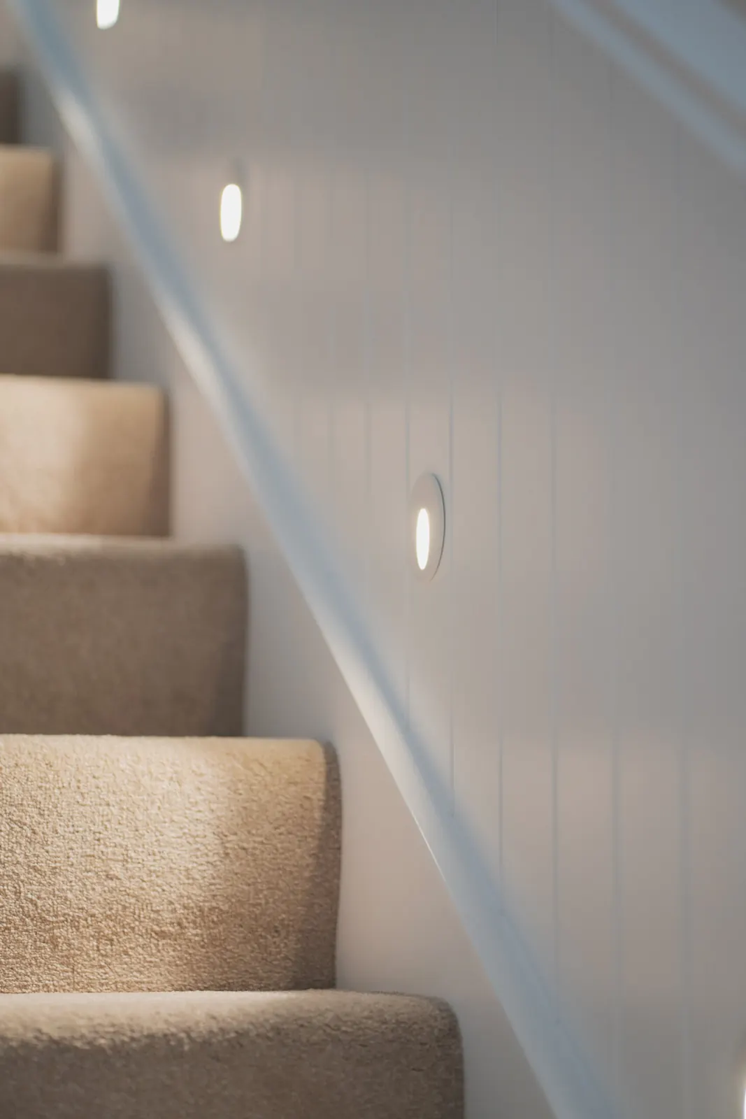 Stair lighting set into the wall beside the steps