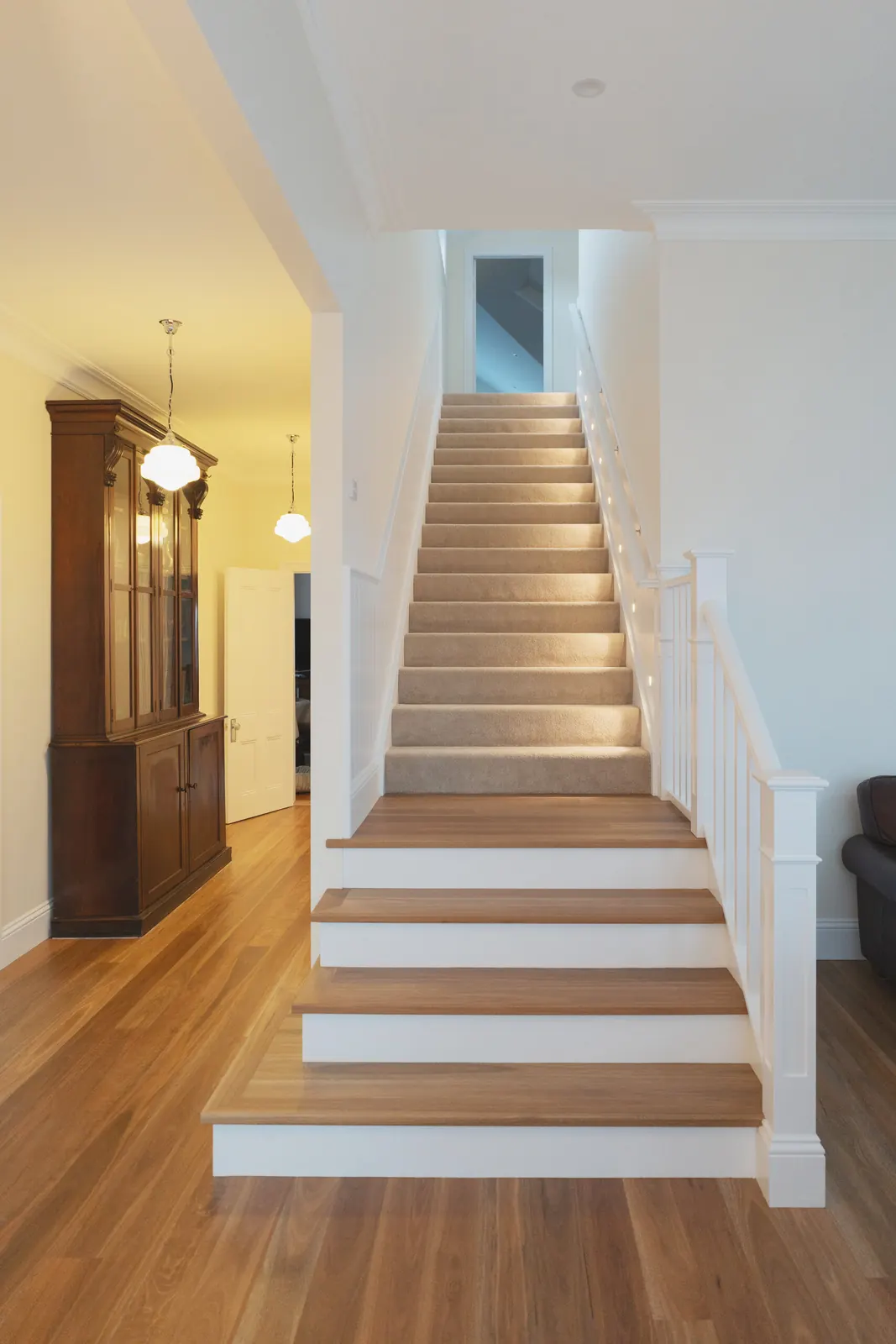The stairs and hallway, with step lights and vintage pendants