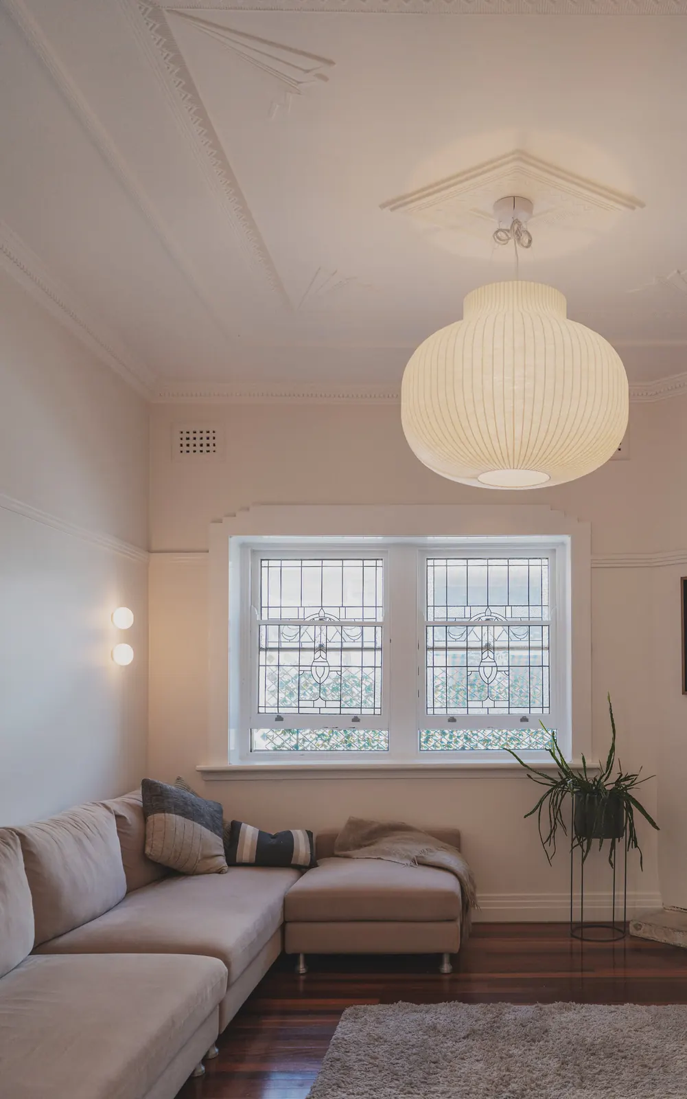 Waxed paper pendant installed alongside orb wall lights