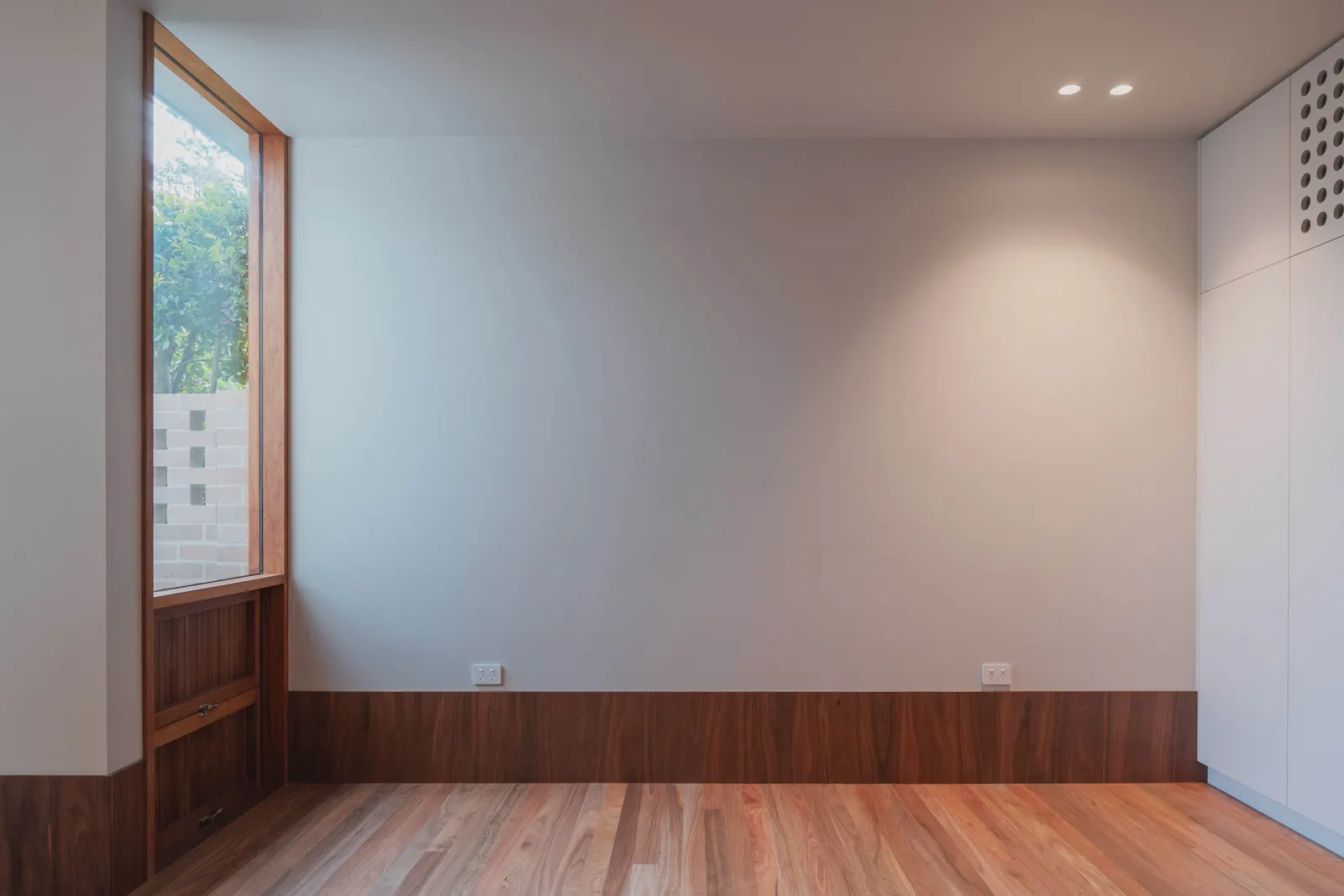 Power outlets aligned along the top of the timber skirting